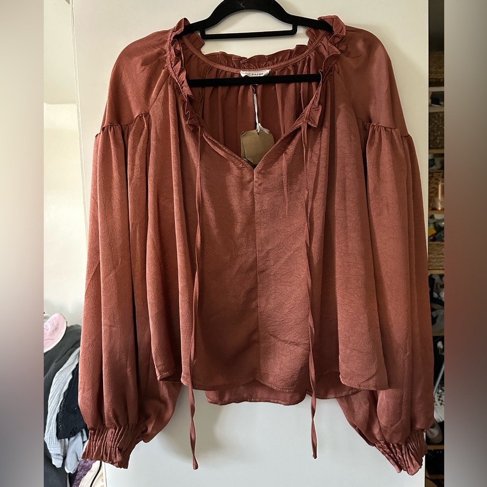 New rust color blouse. Size large. chest 44”Length 22”